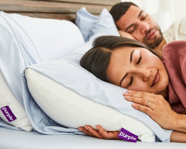 couple sleeping on dressed bed
