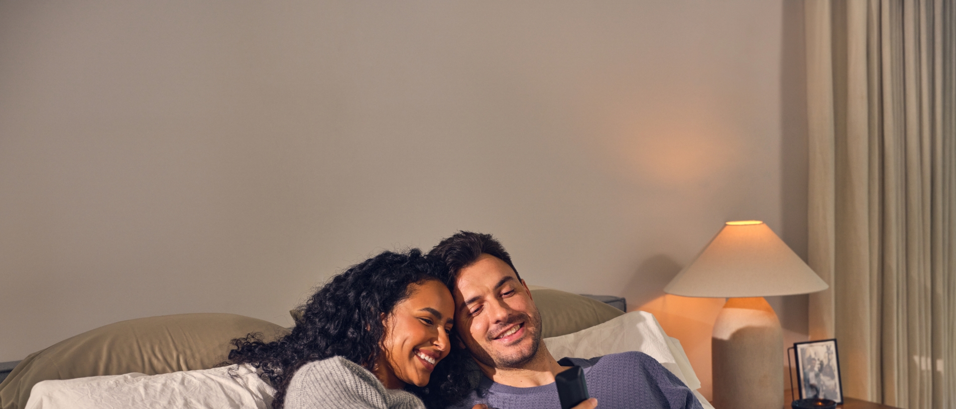 Happy couple laying in bed